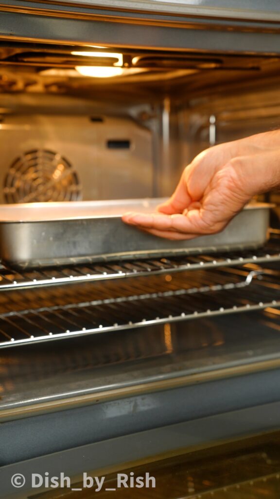 placing tray of chiffon cake batter into the oven