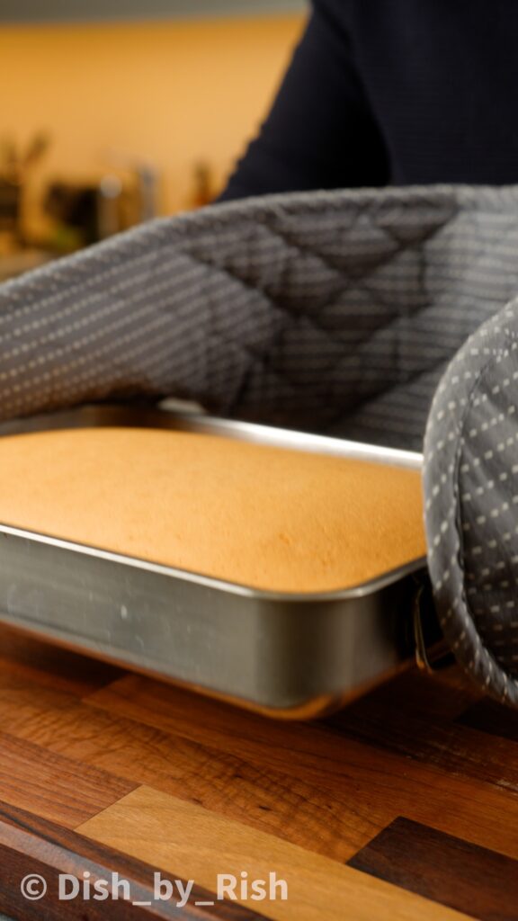 baked chiffon cake being tapped on the counter