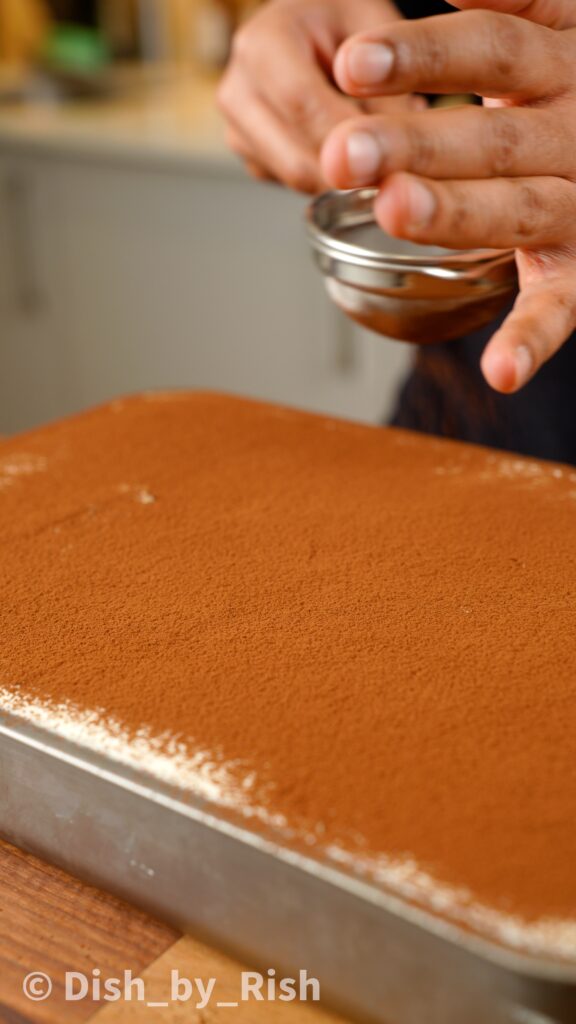 dusting cake with cocoa powder