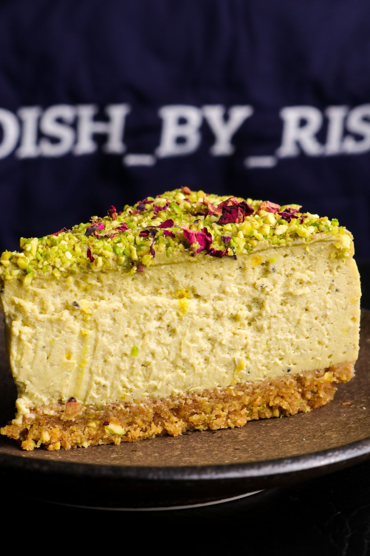 baked pistachio kulfi cheesecake on a plate