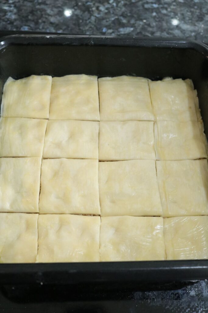 coconut and walnut baklava cut into squares before baking