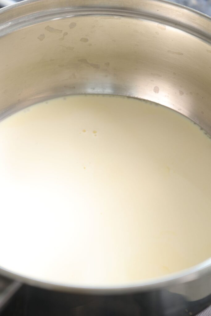 cream being heated in a saucepan