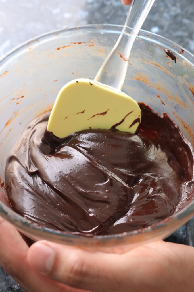 smooth chocolate ganache in a mixing bowl