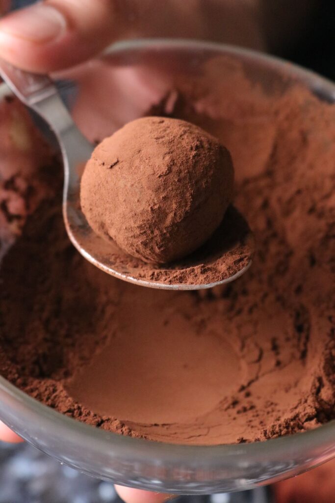 rolling the dark chocolate truffles in cocoa powder