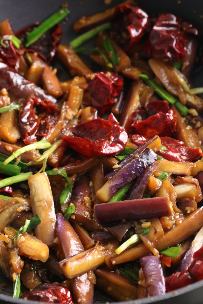 aubergine and garlic chive stir fry in wok