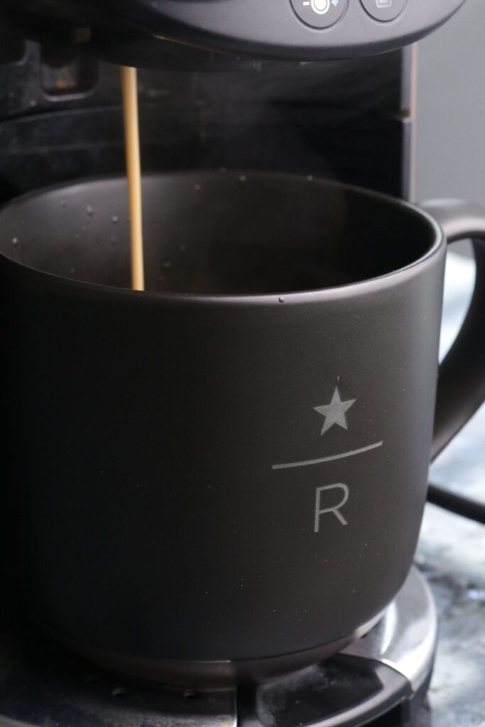 espresso being poured into a mug