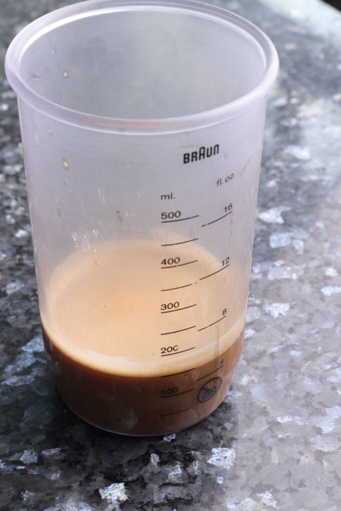 espresso and milk mixed together in a jug