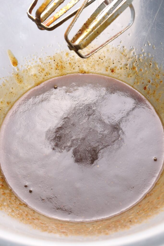 melted butter, sugar, black treacle, vanilla and cardamom whisked in a mixing bowl