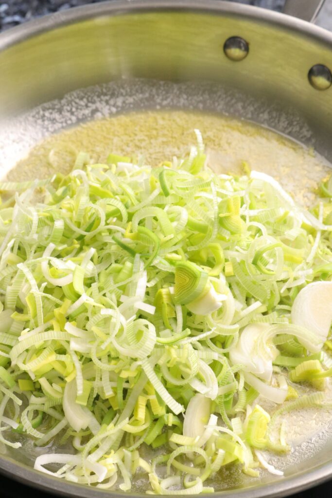 leeks cooking in butter in a pan