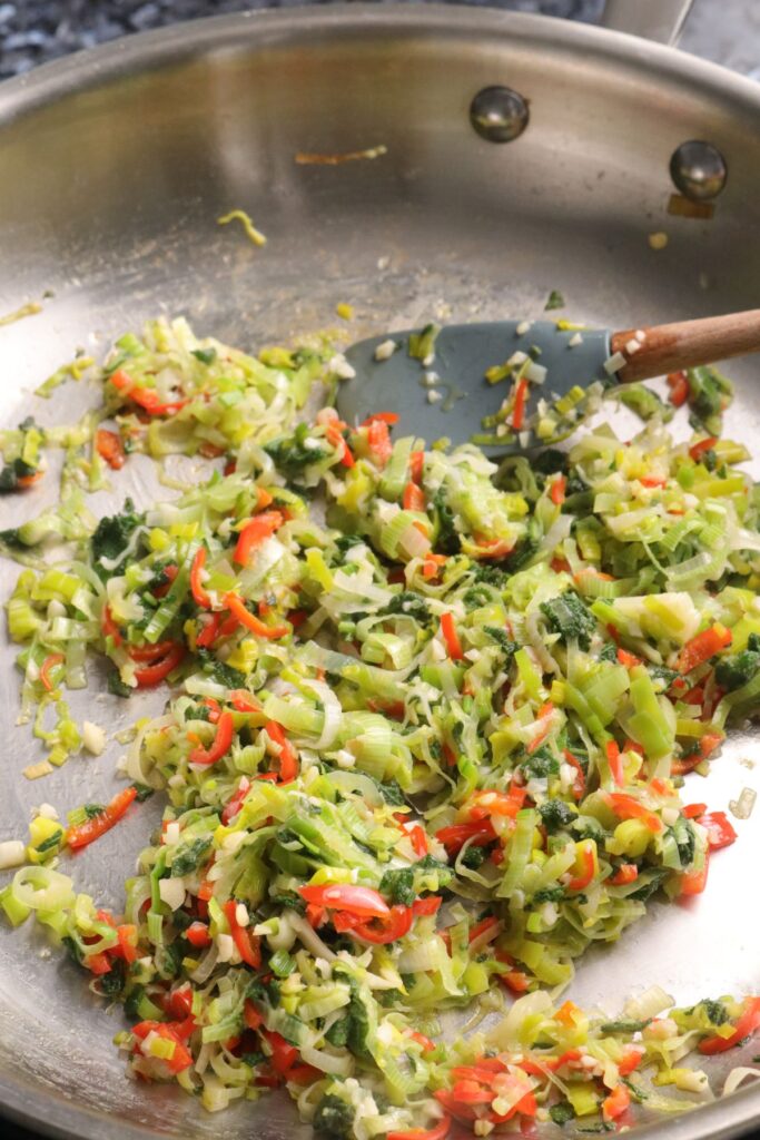 leeks, garlic, red chilli, and sage cooking in butter in a pan