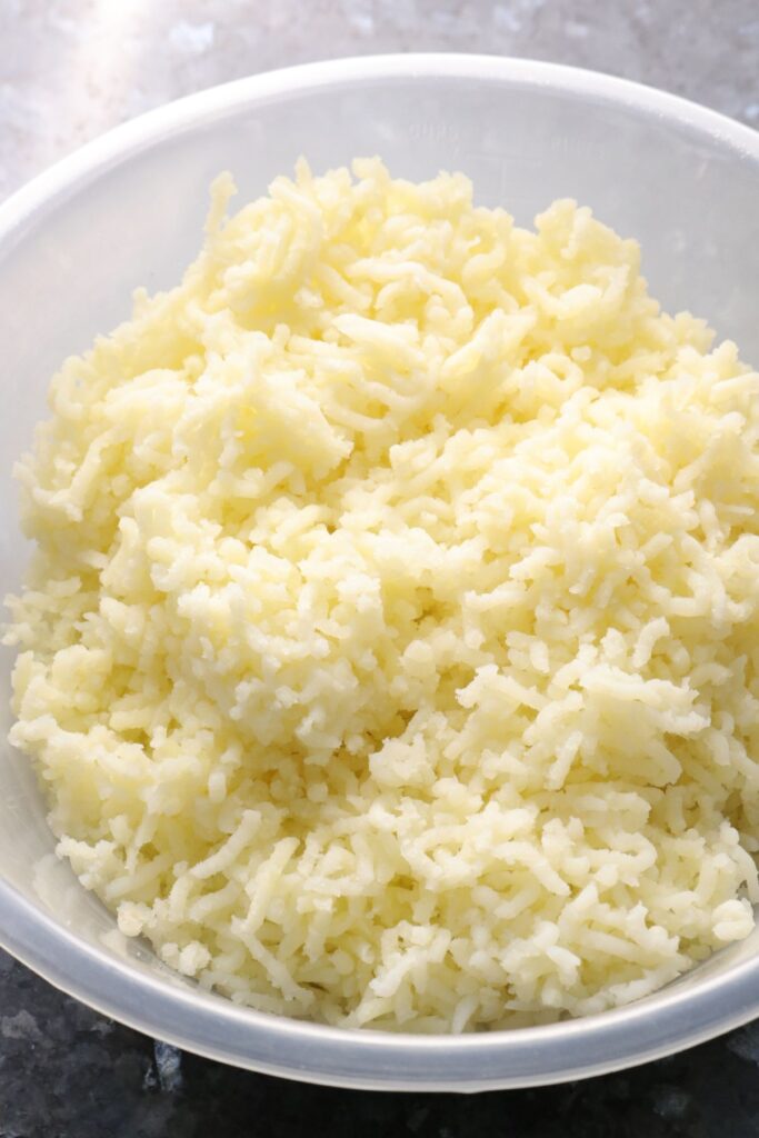 grated potato in a mixing bowl